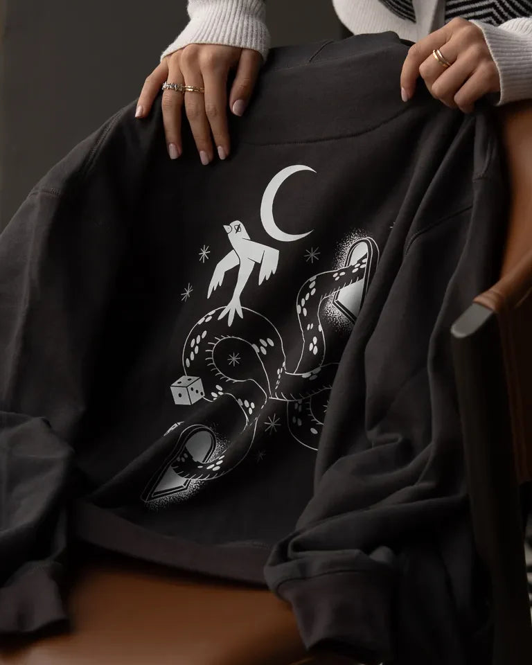 Snake Eyes Hoodie by Naji Al-Ali LMNBCK — black premium cotton hoodie with monochrome LMNBCK graphic illustration