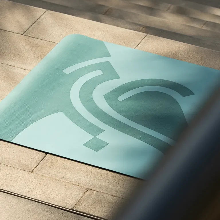 Eternal Yoga Mat by Wissam Shawkat — full-length yoga mat printed with flowing Arabic calligraphy in black and red