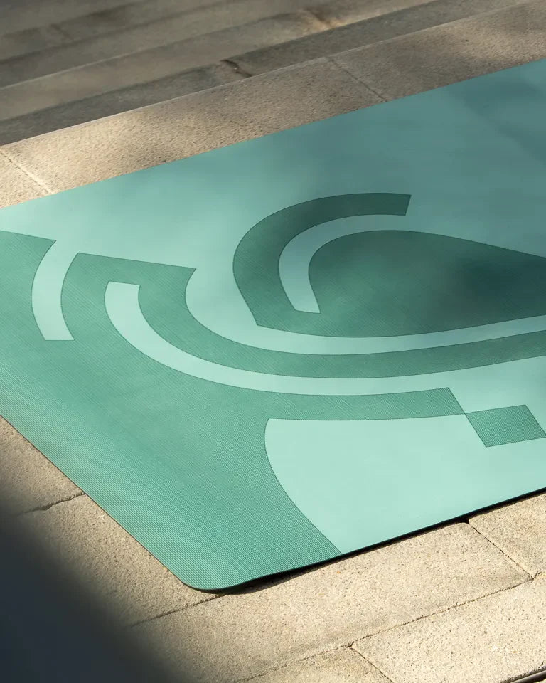 Eternal Yoga Mat by Wissam Shawkat — full-length yoga mat printed with flowing Arabic calligraphy in black and red