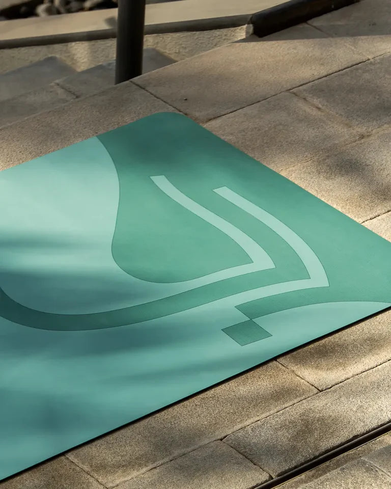 Eternal Yoga Mat by Wissam Shawkat — full-length yoga mat printed with flowing Arabic calligraphy in black and red