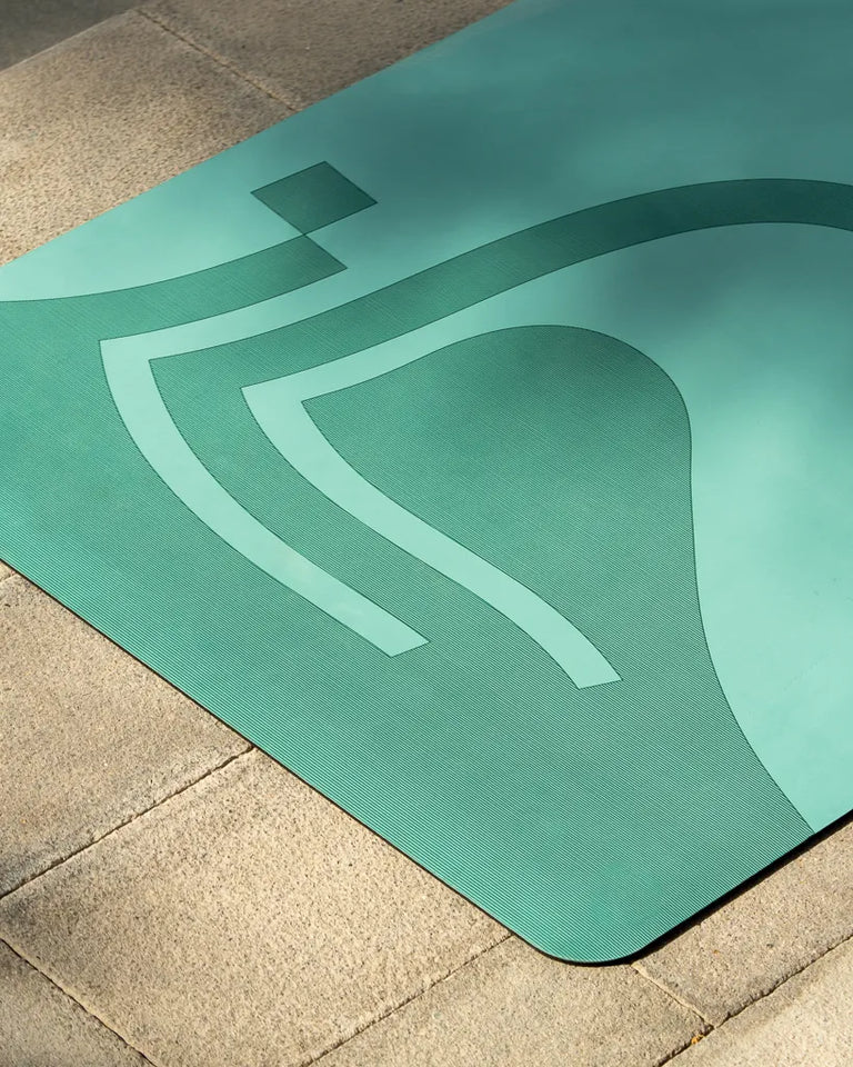 Eternal Yoga Mat by Wissam Shawkat — full-length yoga mat printed with flowing Arabic calligraphy in black and red