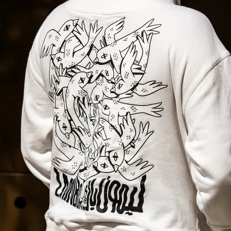 Free Birds Hoodie by Naji Al-Ali LMNBCK — premium cotton hoodie with bold black bird illustration