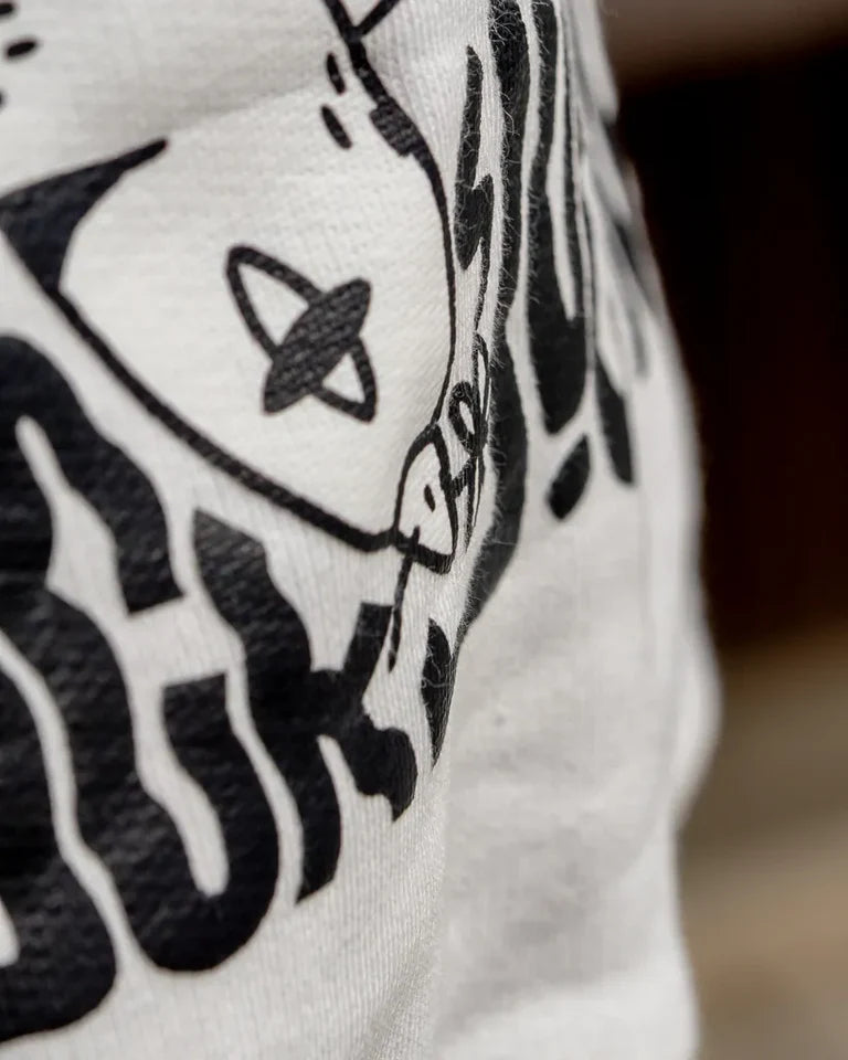 Free Birds Hoodie by Naji Al-Ali LMNBCK — premium cotton hoodie with bold black bird illustration