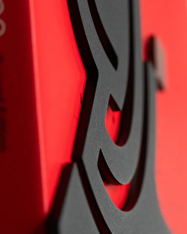 Eternal Bookends by Wissam Shawkat — precision-cut steel bookends with Arabic calligraphy in matte black and red