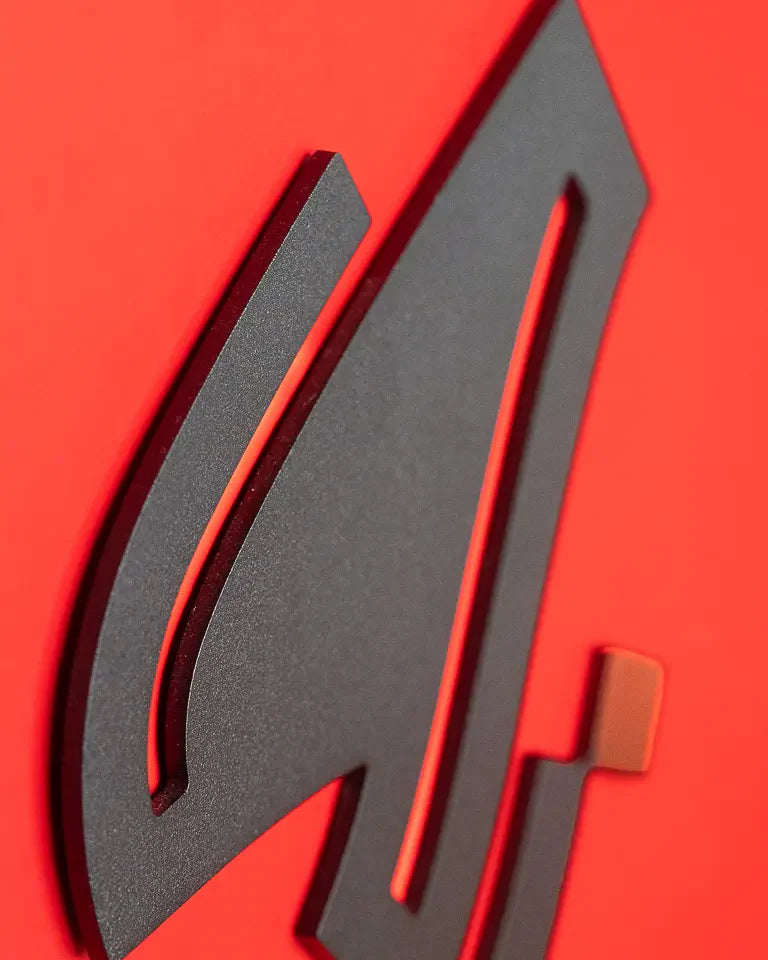 Eternal Bookends by Wissam Shawkat — precision-cut steel bookends with Arabic calligraphy in matte black and red