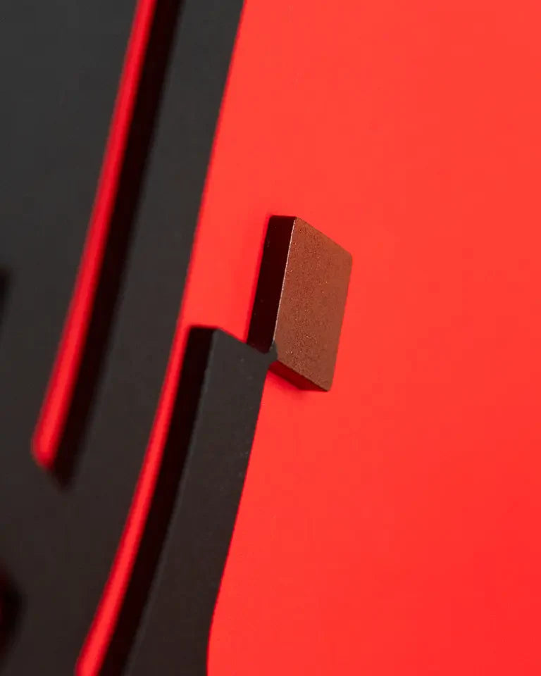 Eternal Bookends by Wissam Shawkat — precision-cut steel bookends with Arabic calligraphy in matte black and red
