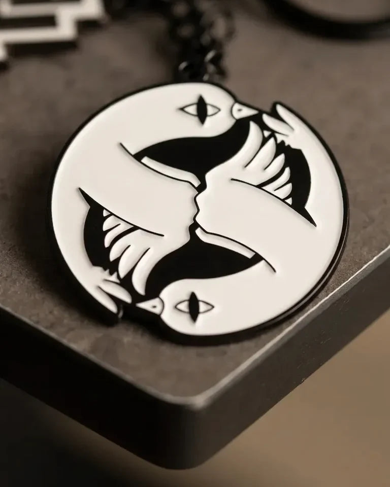 Peace and Love Keychain by Naji Al-Ali — black and white enamel keychain with mirrored LMNBCK bird artwork