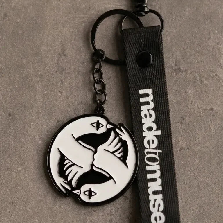 Peace and Love Keychain by Naji Al-Ali — black and white enamel keychain with mirrored LMNBCK bird artwork