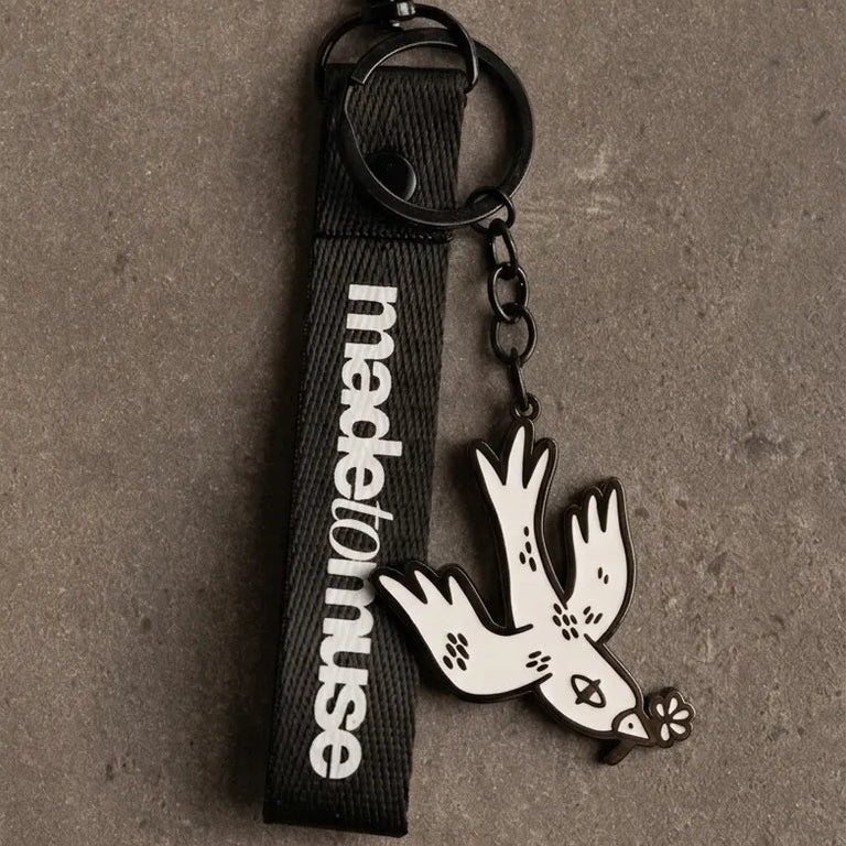 Free Bird Keychain by Naji Al-Ali — enamel keychain with iconic white and black bird design by LMNBCK