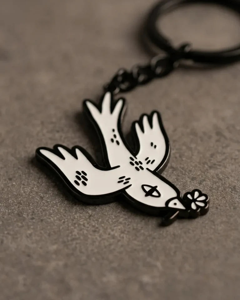 Free Bird Keychain by Naji Al-Ali — enamel keychain with iconic white and black bird design by LMNBCK